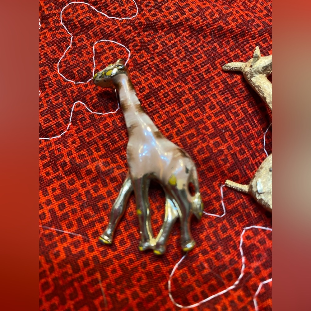Two animal pins. I am going to say they are both giraffes.